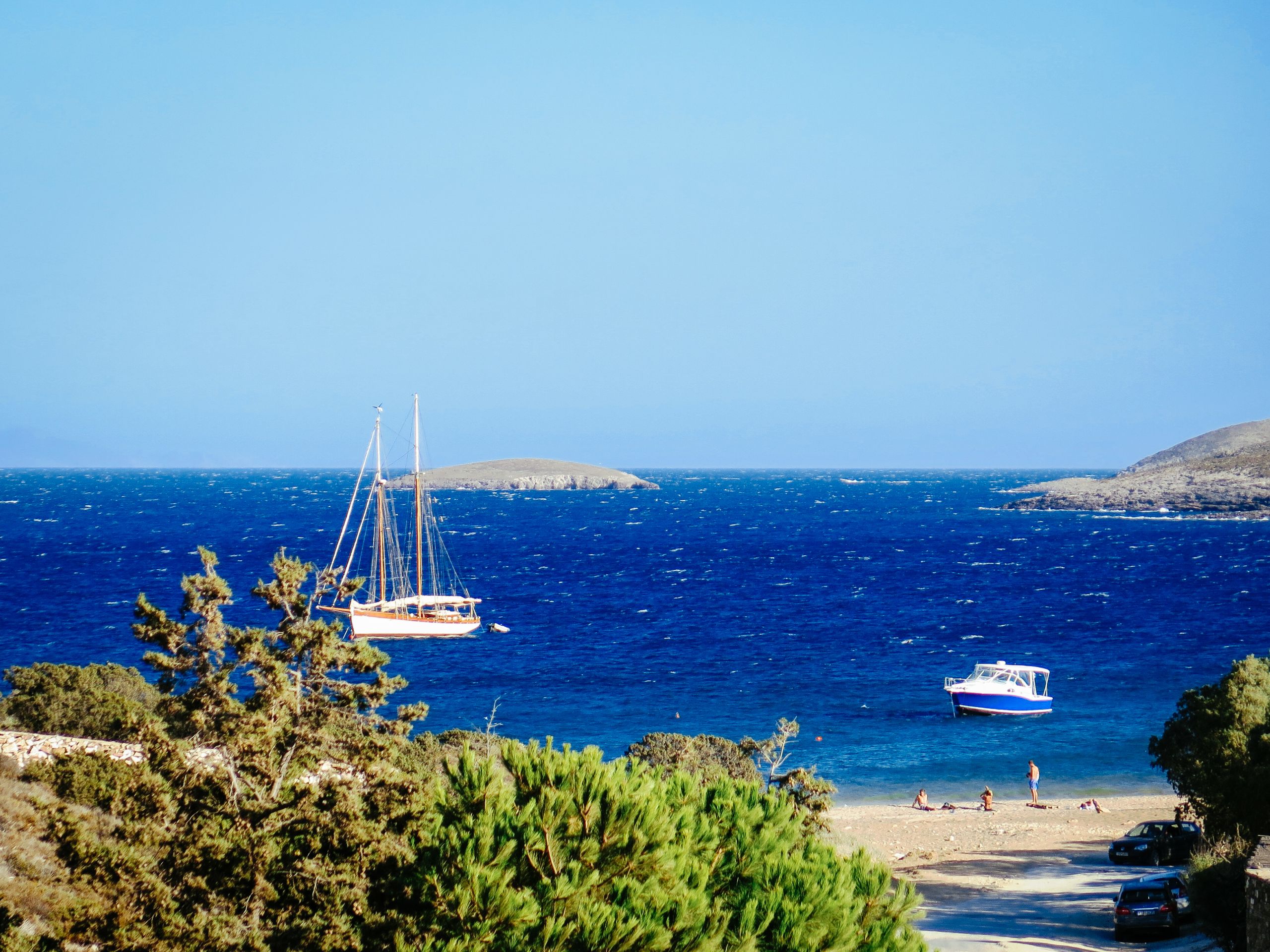 Mare blu e costa rocciosa vista da un sentiero panoramico, Santorini, Grecia.